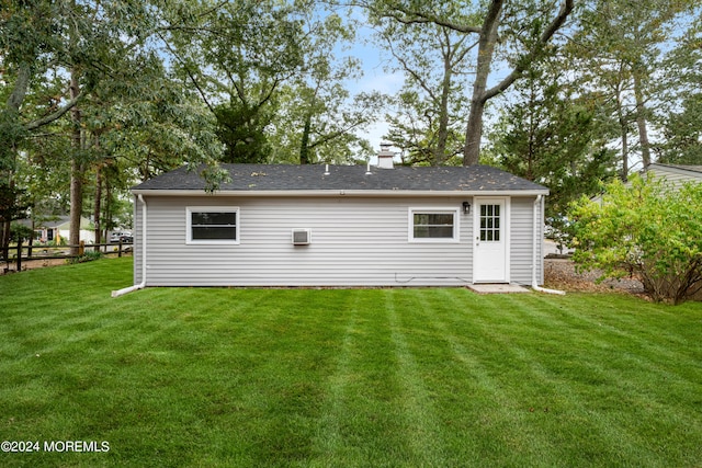 rear view of house with a yard