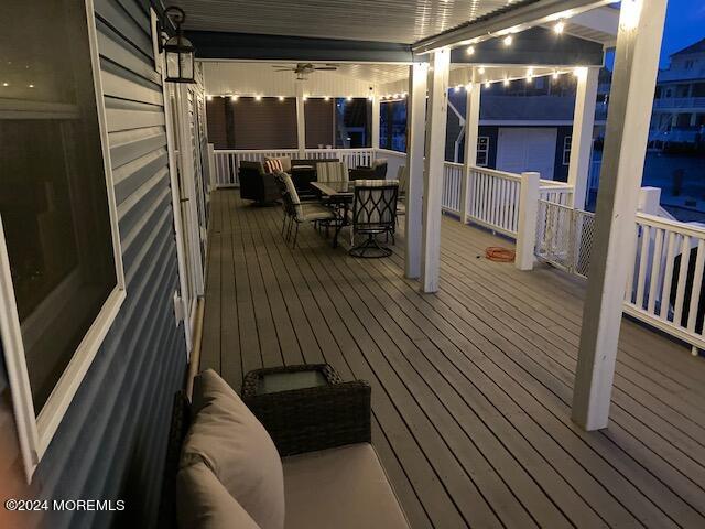 wooden deck featuring ceiling fan