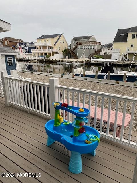 wooden terrace featuring a water view