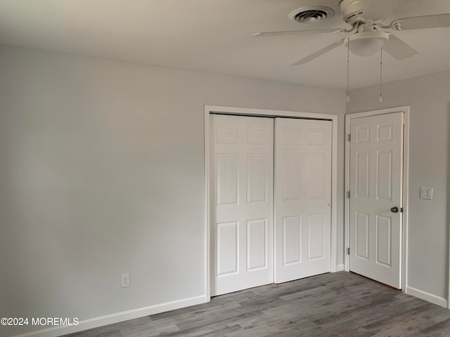 unfurnished bedroom featuring a closet, ceiling fan, and hardwood / wood-style floors