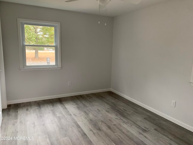 unfurnished room with hardwood / wood-style floors and ceiling fan