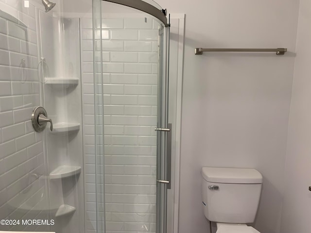 bathroom with walk in shower and toilet