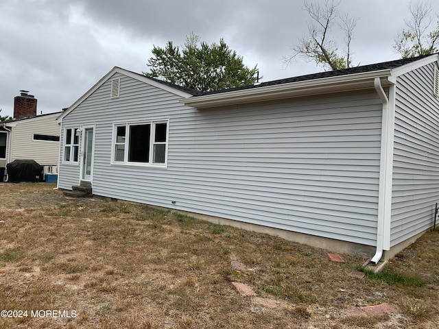 view of property exterior featuring a yard