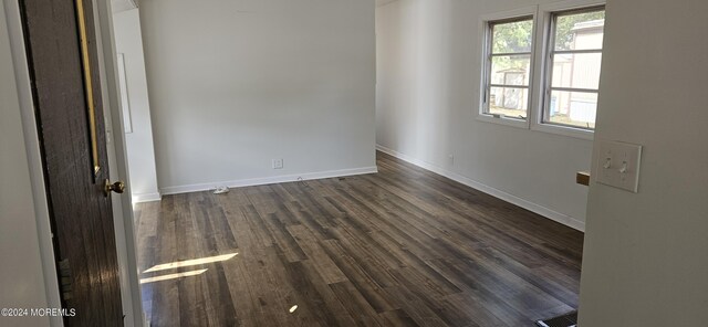 empty room featuring dark wood-type flooring