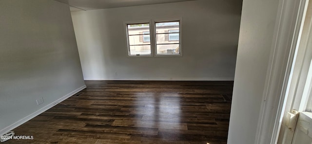 spare room featuring dark hardwood / wood-style flooring