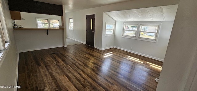 unfurnished living room with lofted ceiling and dark hardwood / wood-style floors