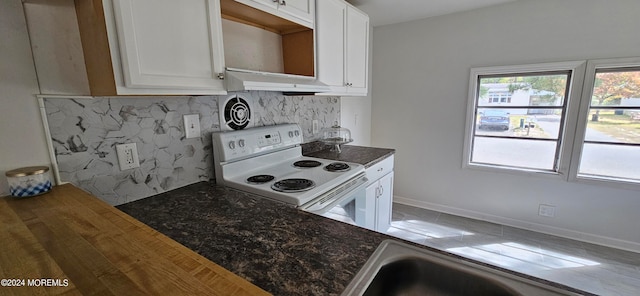 kitchen with hardwood / wood-style floors, electric range, and white cabinetry