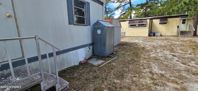 view of side of property with a storage unit