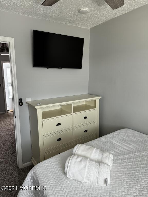 carpeted bedroom featuring a textured ceiling