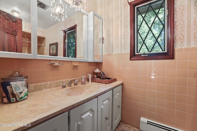 bathroom featuring vanity, baseboard heating, and tile walls