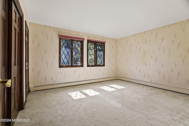 spare room featuring light carpet