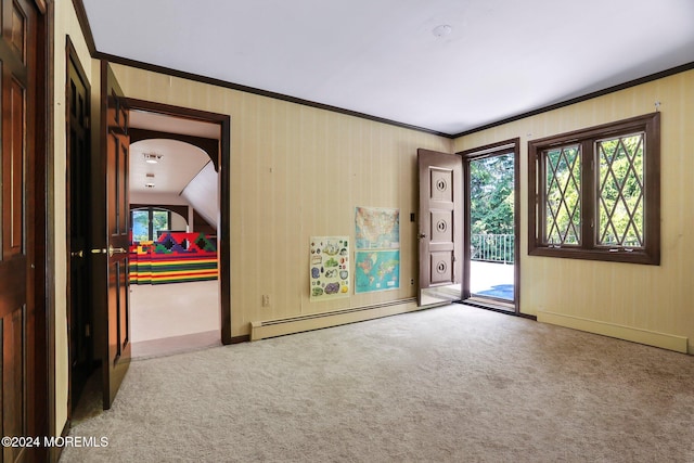 carpeted spare room featuring crown molding, baseboard heating, and lofted ceiling