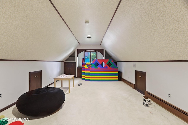 rec room featuring a textured ceiling, carpet, vaulted ceiling, and a baseboard heating unit