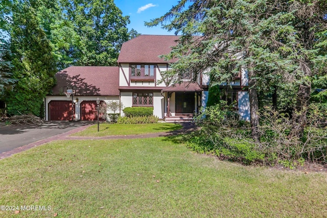 view of front of home with a garage and a front yard