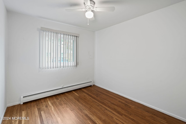 empty room featuring ceiling fan, baseboard heating, and hardwood / wood-style flooring