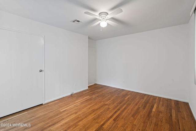 spare room with ceiling fan and hardwood / wood-style flooring