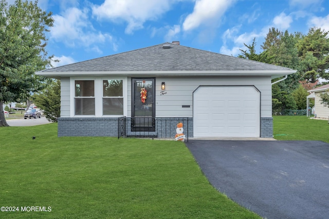 single story home featuring a garage and a front lawn