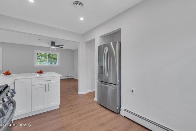 kitchen featuring ceiling fan, a baseboard heating unit, white cabinetry, stainless steel appliances, and light hardwood / wood-style floors