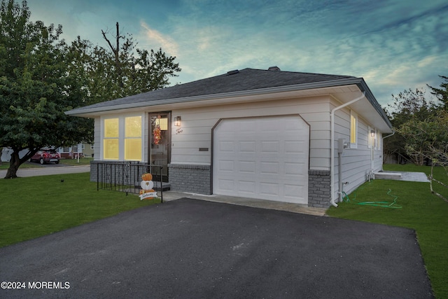 view of front facade featuring a garage and a front lawn