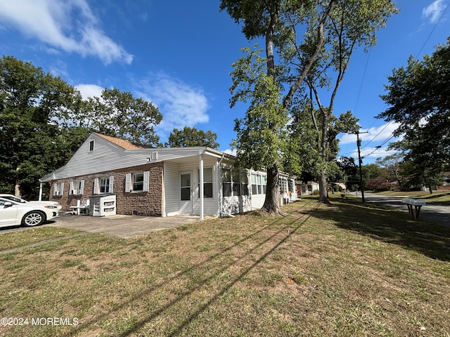 view of side of home featuring a lawn