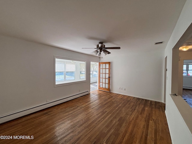 spare room with a baseboard radiator, ceiling fan, and dark hardwood / wood-style floors