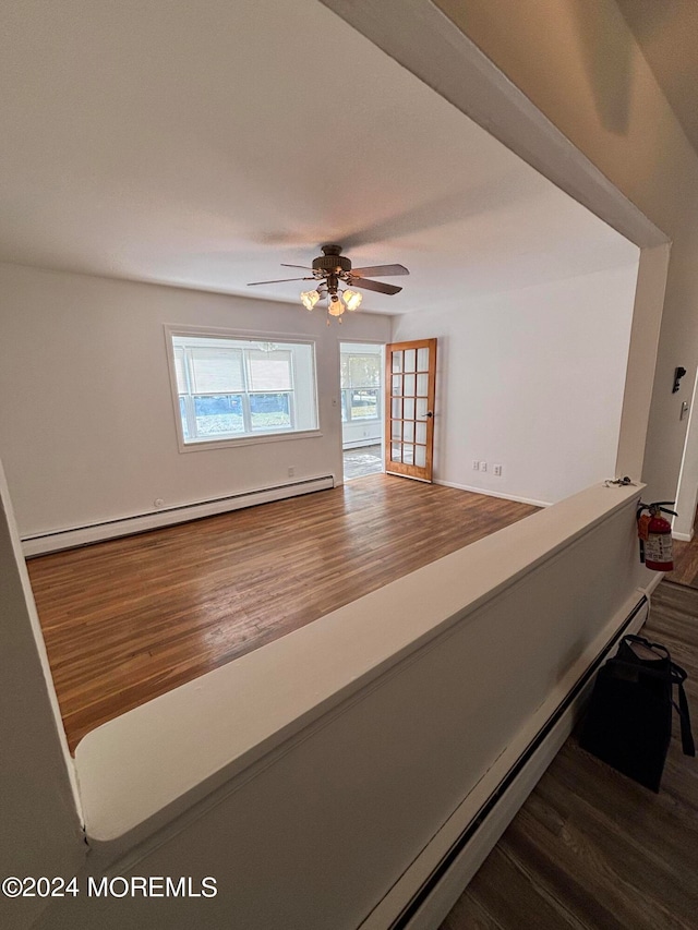 hallway featuring a baseboard radiator and hardwood / wood-style floors