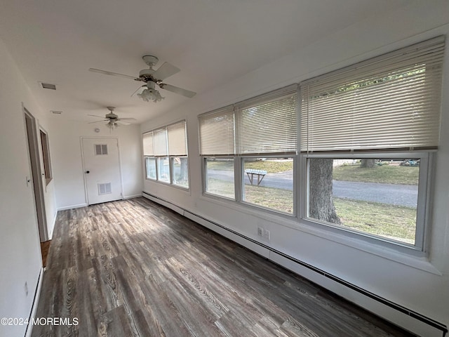 unfurnished sunroom featuring baseboard heating and ceiling fan