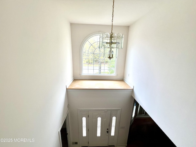 entryway with a chandelier