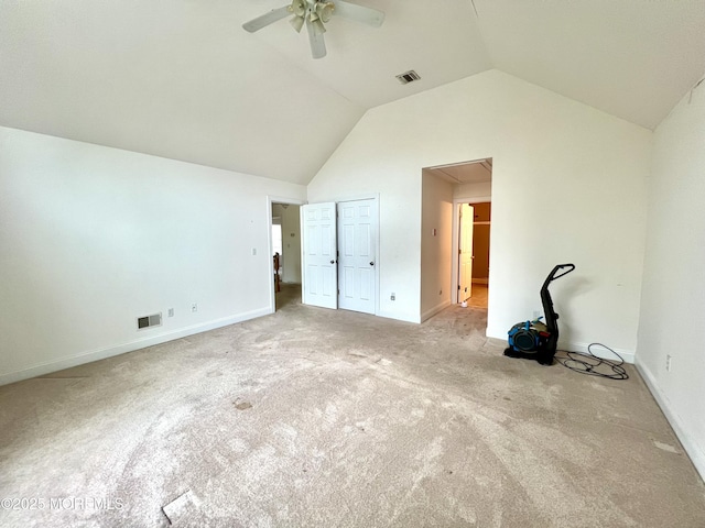 unfurnished bedroom with attic access, visible vents, vaulted ceiling, baseboards, and carpet