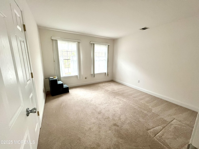 unfurnished room with baseboards, carpet flooring, and visible vents