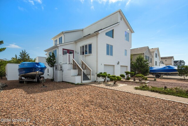 back of house with a garage