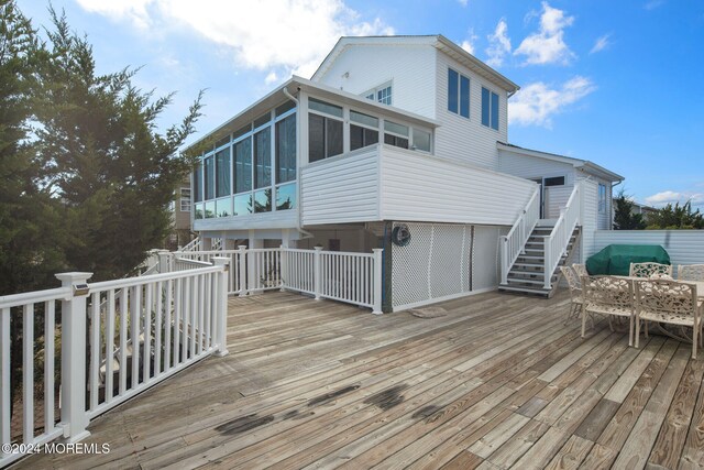 wooden deck with a sunroom