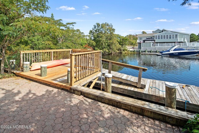 dock area featuring a patio and a deck with water view