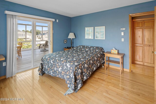 bedroom with wood-type flooring and access to exterior