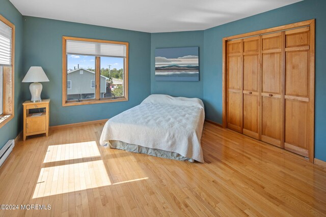 bedroom with light hardwood / wood-style flooring and a closet