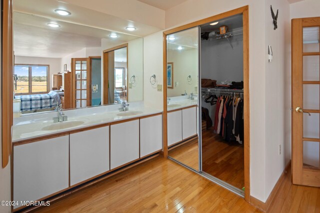 bathroom featuring hardwood / wood-style flooring and vanity