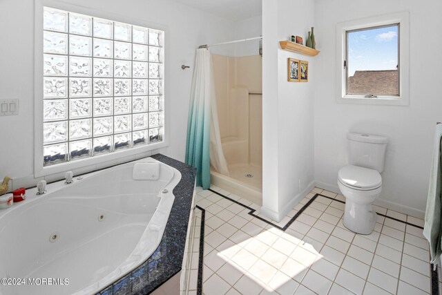 bathroom featuring tile patterned flooring, separate shower and tub, and toilet