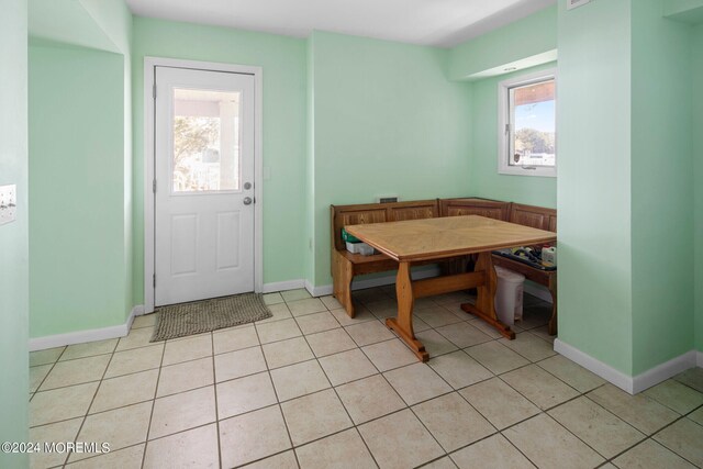 dining room with light tile patterned flooring, breakfast area, and plenty of natural light