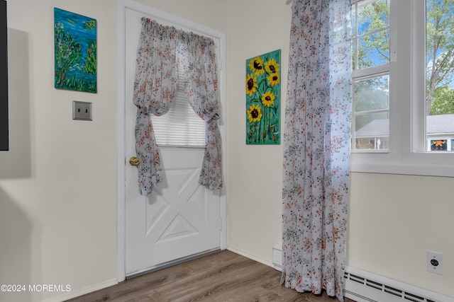 entryway featuring hardwood / wood-style floors and a baseboard heating unit