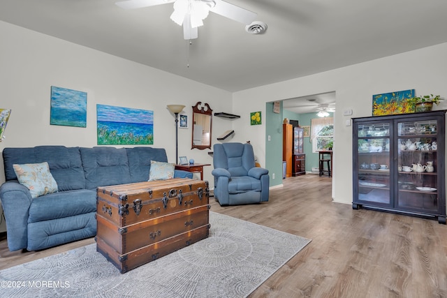 living room with light wood-type flooring and ceiling fan