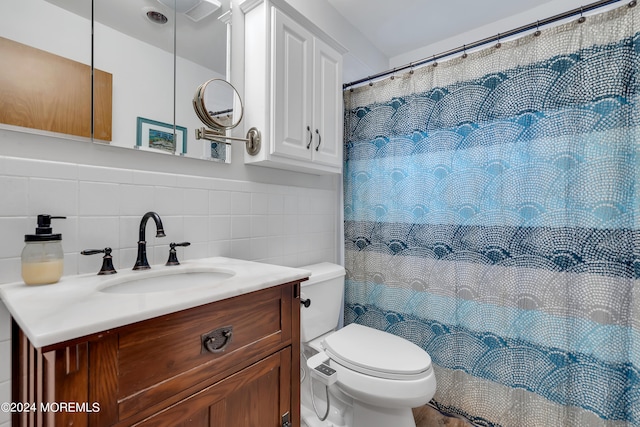 bathroom featuring vanity, tile walls, toilet, and curtained shower