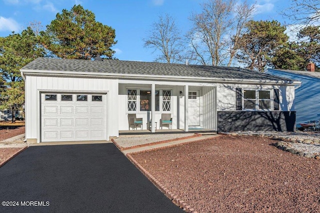 single story home featuring a porch and a garage