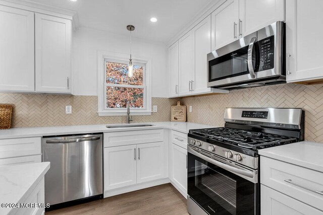 kitchen with white cabinetry, sink, dark hardwood / wood-style floors, and appliances with stainless steel finishes