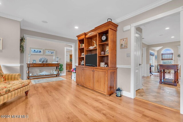 living room featuring ornamental molding and light hardwood / wood-style floors