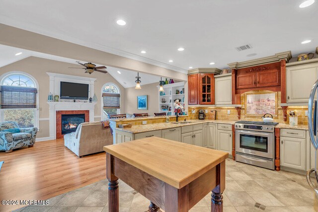 kitchen featuring appliances with stainless steel finishes, plenty of natural light, and vaulted ceiling