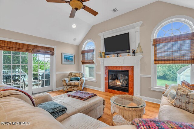 living room featuring a healthy amount of sunlight, vaulted ceiling, and ceiling fan