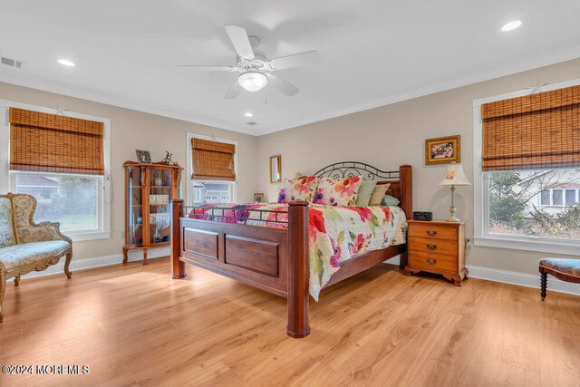 bedroom featuring ceiling fan, light hardwood / wood-style flooring, and crown molding