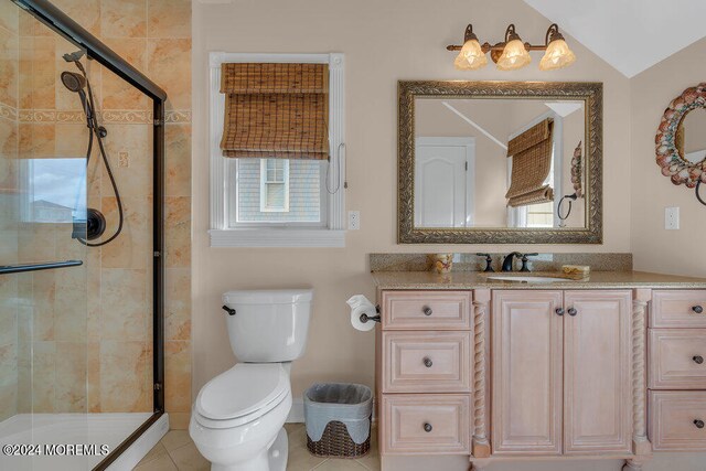 bathroom with vanity, lofted ceiling, tile patterned flooring, a shower with shower door, and toilet