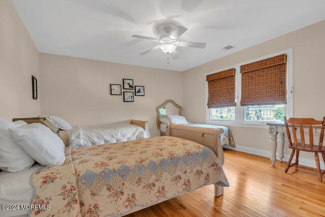 bedroom featuring light hardwood / wood-style flooring and ceiling fan