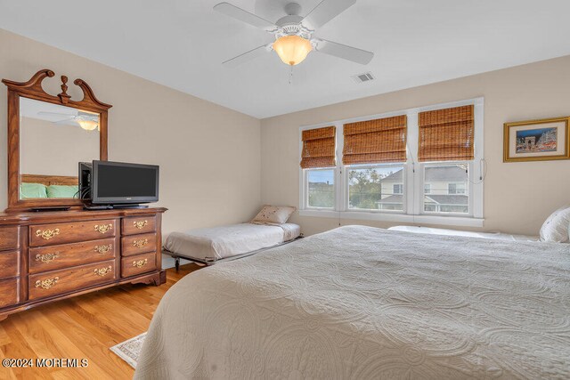 bedroom featuring ceiling fan and light hardwood / wood-style flooring